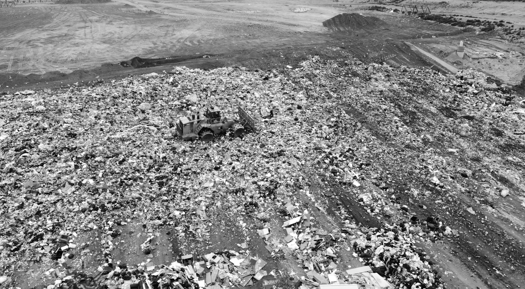 Bulldozer compacting waste at a landfill site
